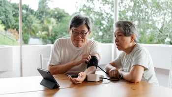 Health insurance: couple checking blood pressure 2240243171