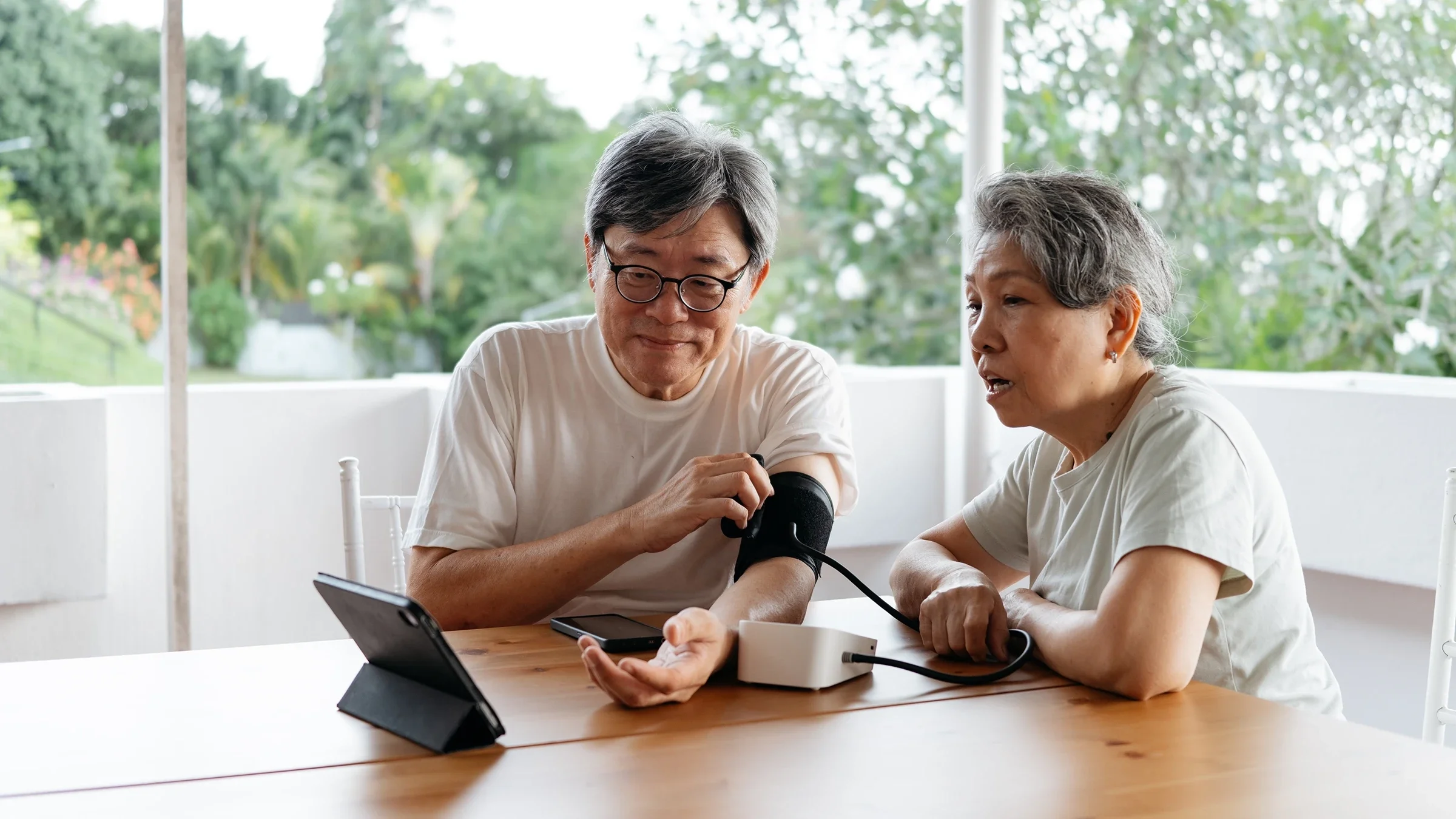 Adults checking their blood pressure.