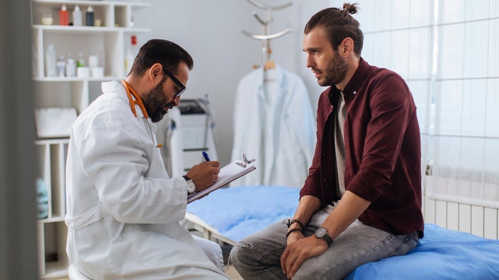 Patient telling medical professional his symptoms.