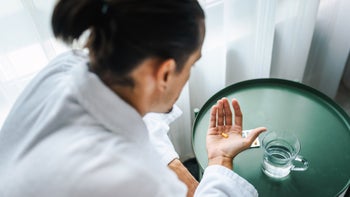 Slidenafil: generic: man in robe taking pill 1299064976