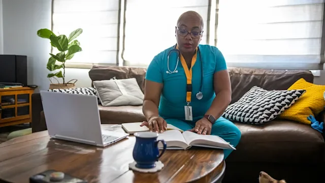 Health: Nurses: nurse studying textbook 1301454918