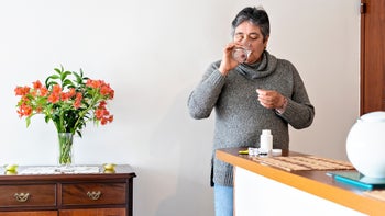 Health: Epclusa: senior woman taking medication bright room-1317543683