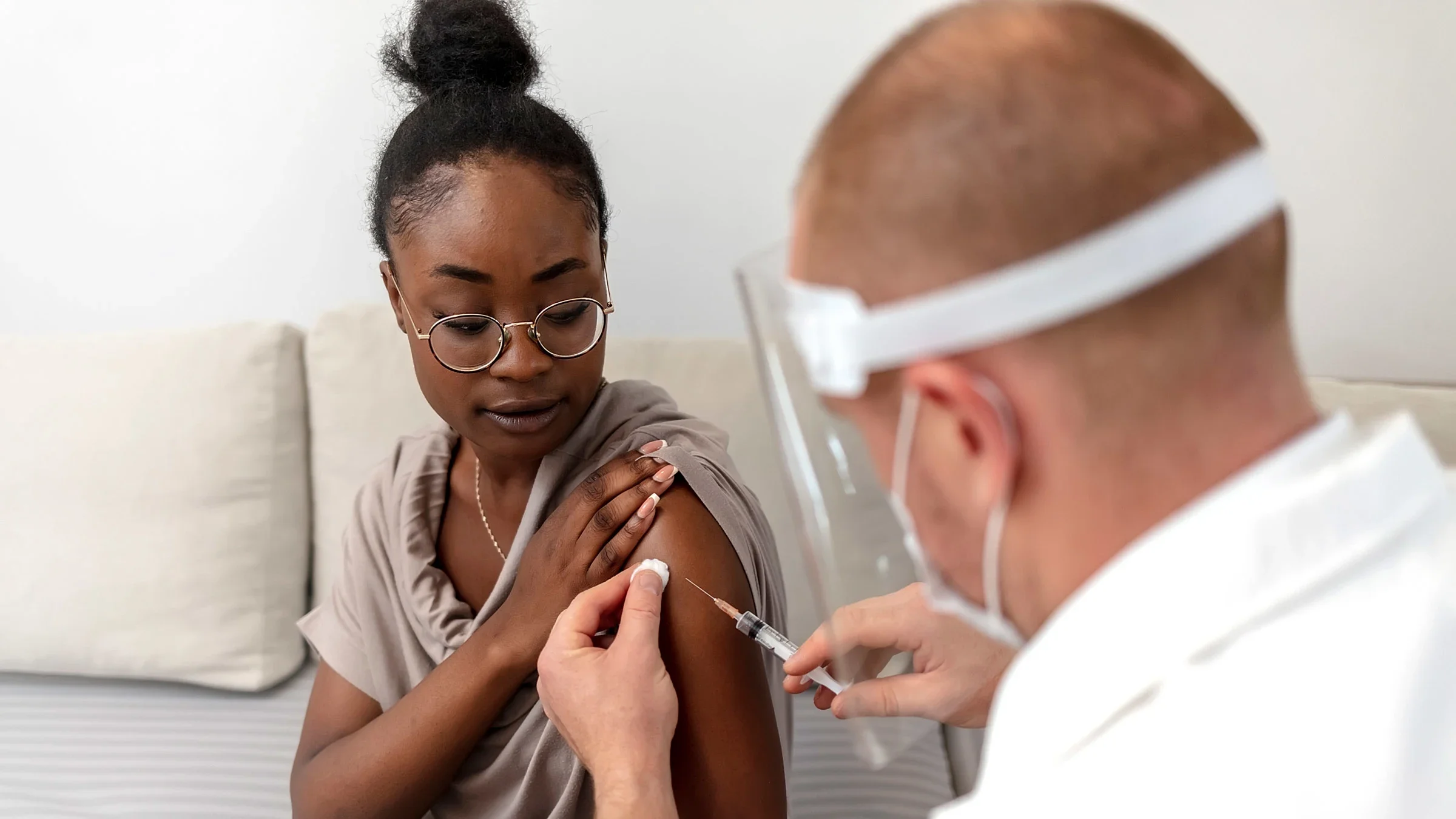 A doctor about to inject a vaccine into a patient's arm.
Jelena Stanojkovic/iStock via Getty Images Plus 
