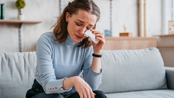 Health: Mental health: woman crying on couch 1374841003