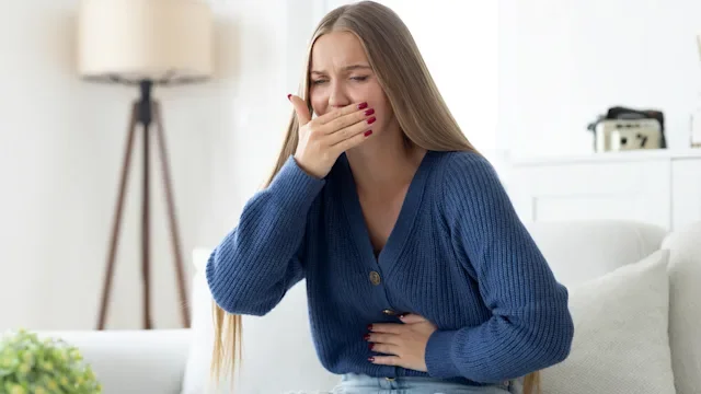 Nausea: woman covering mouth feeling nausea 2175396754