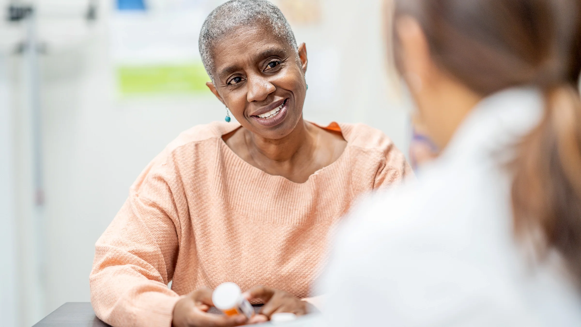 Woman speaking to a healthcare professional about medication