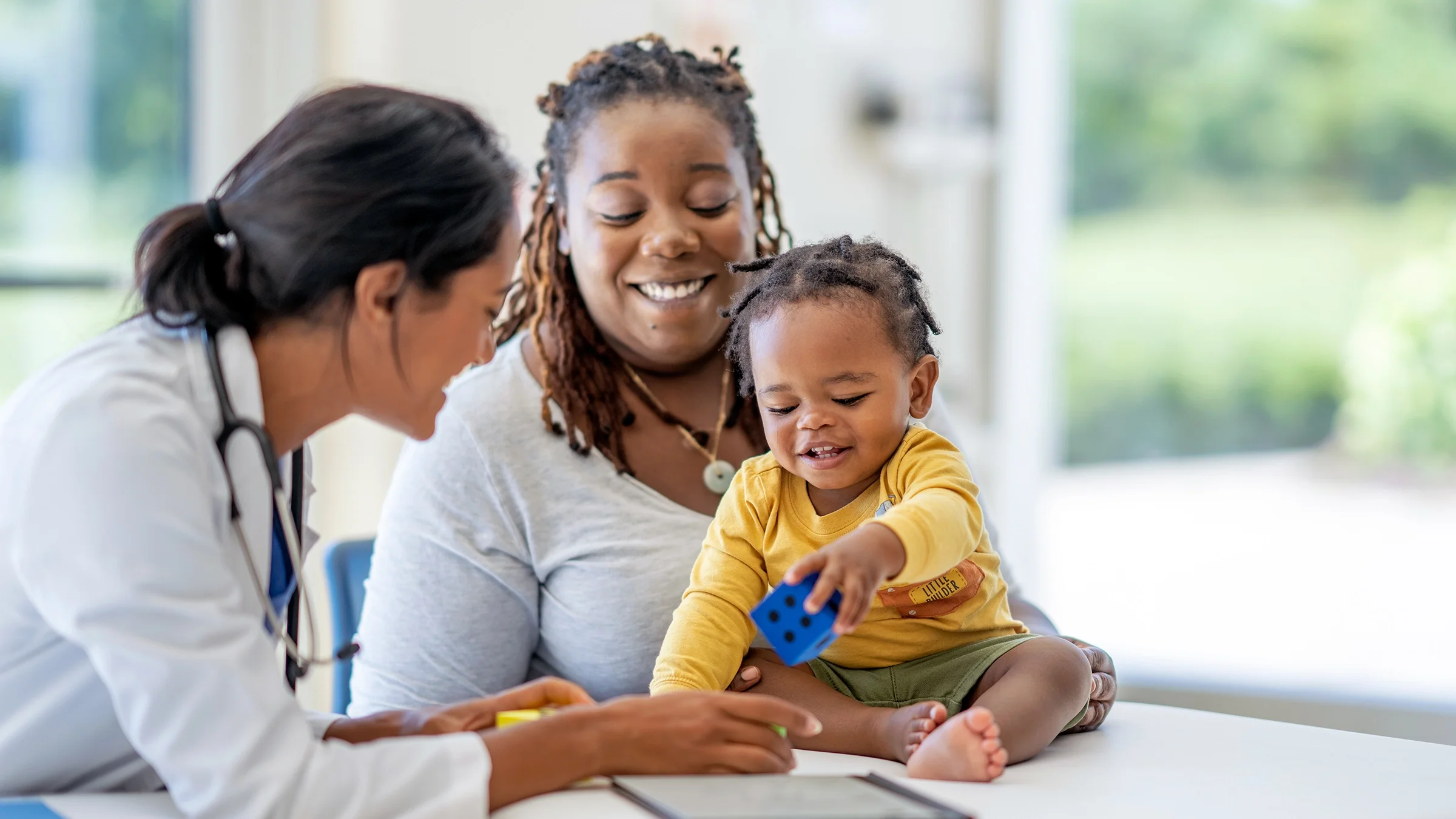 A mother and her infant son are visiting the doctor.