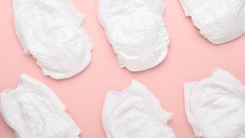 parenthood-pregnancy: : baby: newborn: diapers on pink background-1331852160
