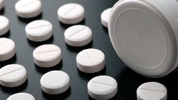 adderall: prescription: white pills with bottle on black background-1034956582
