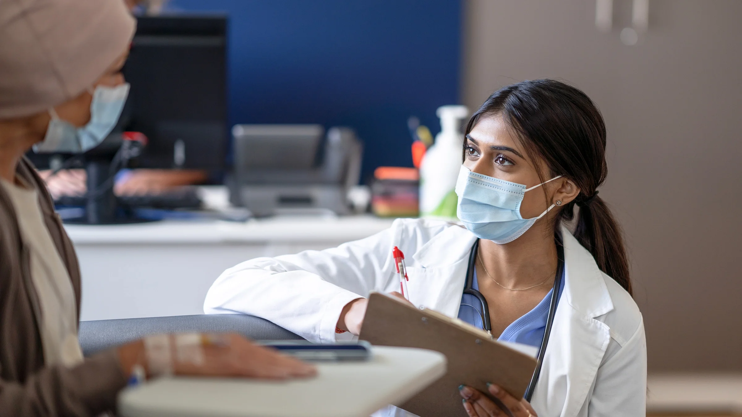 A doctor talks with a cancer patient.