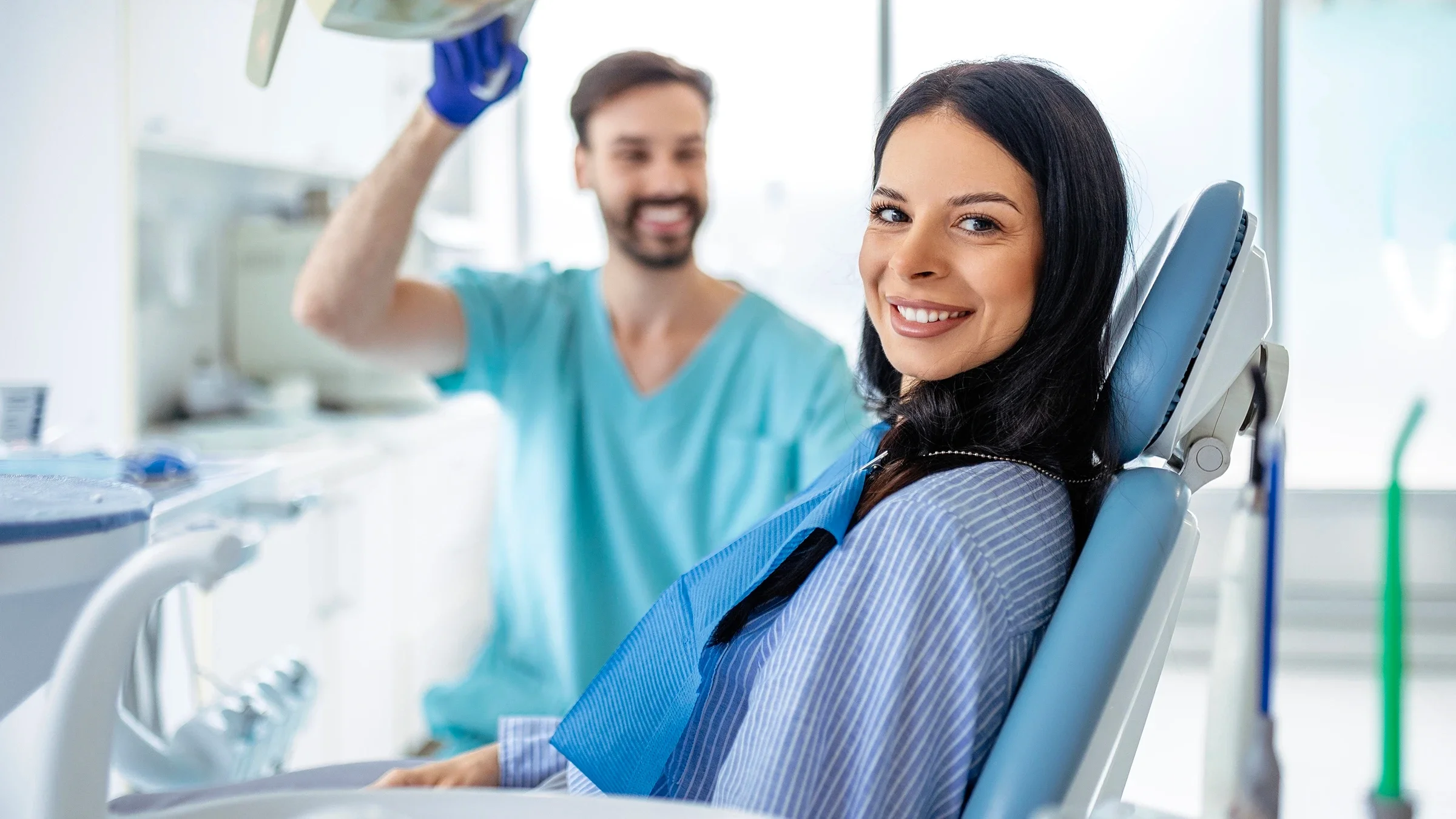 A patient sits in a dental chair.