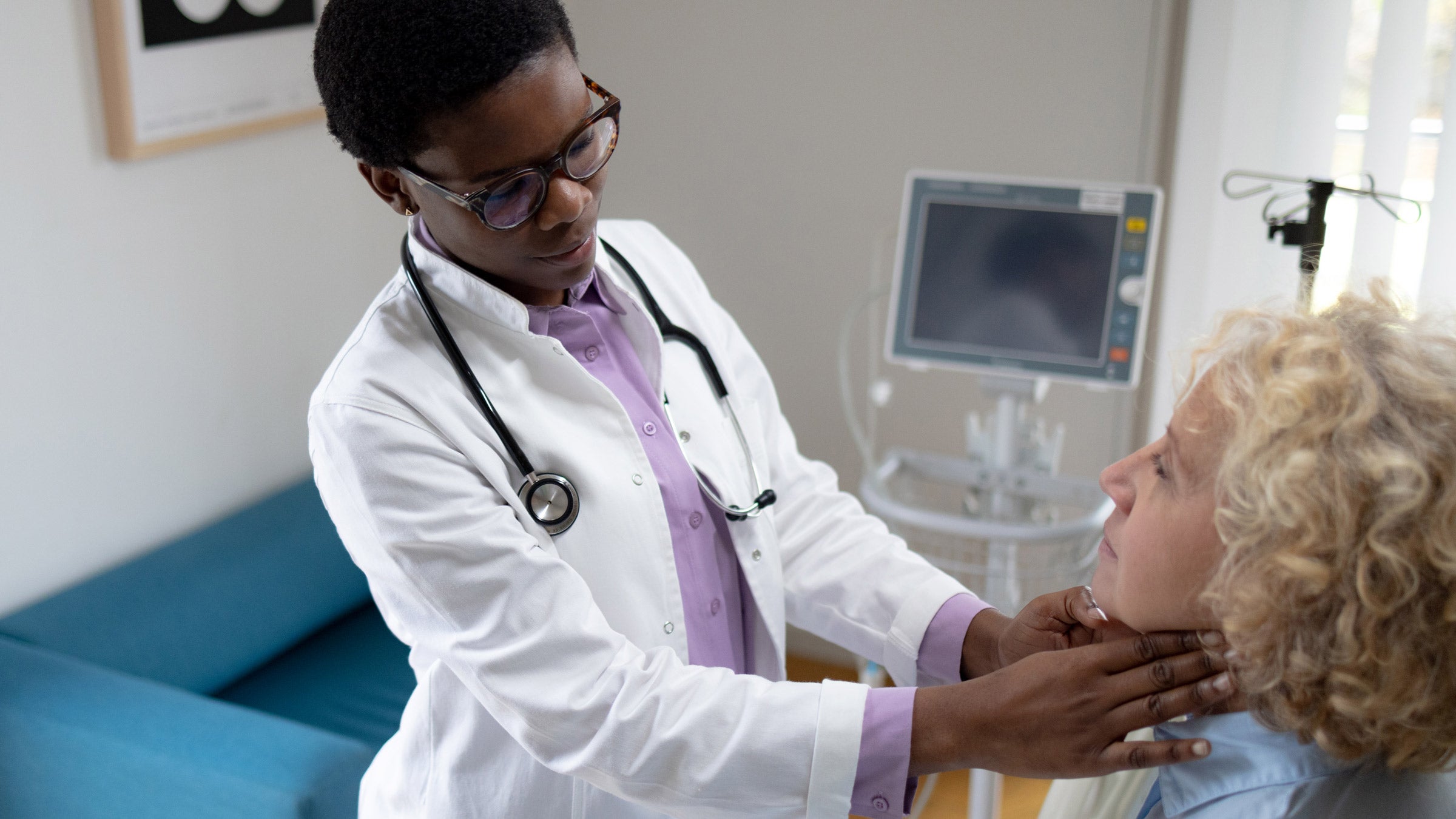 Hypothyroidism: doctor examining lymph nodes 1448358320