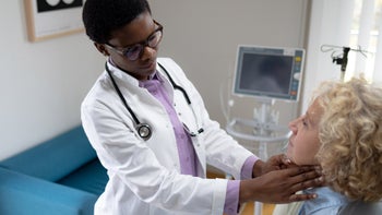 Hypothyroidism: doctor examining lymph nodes 1448358320