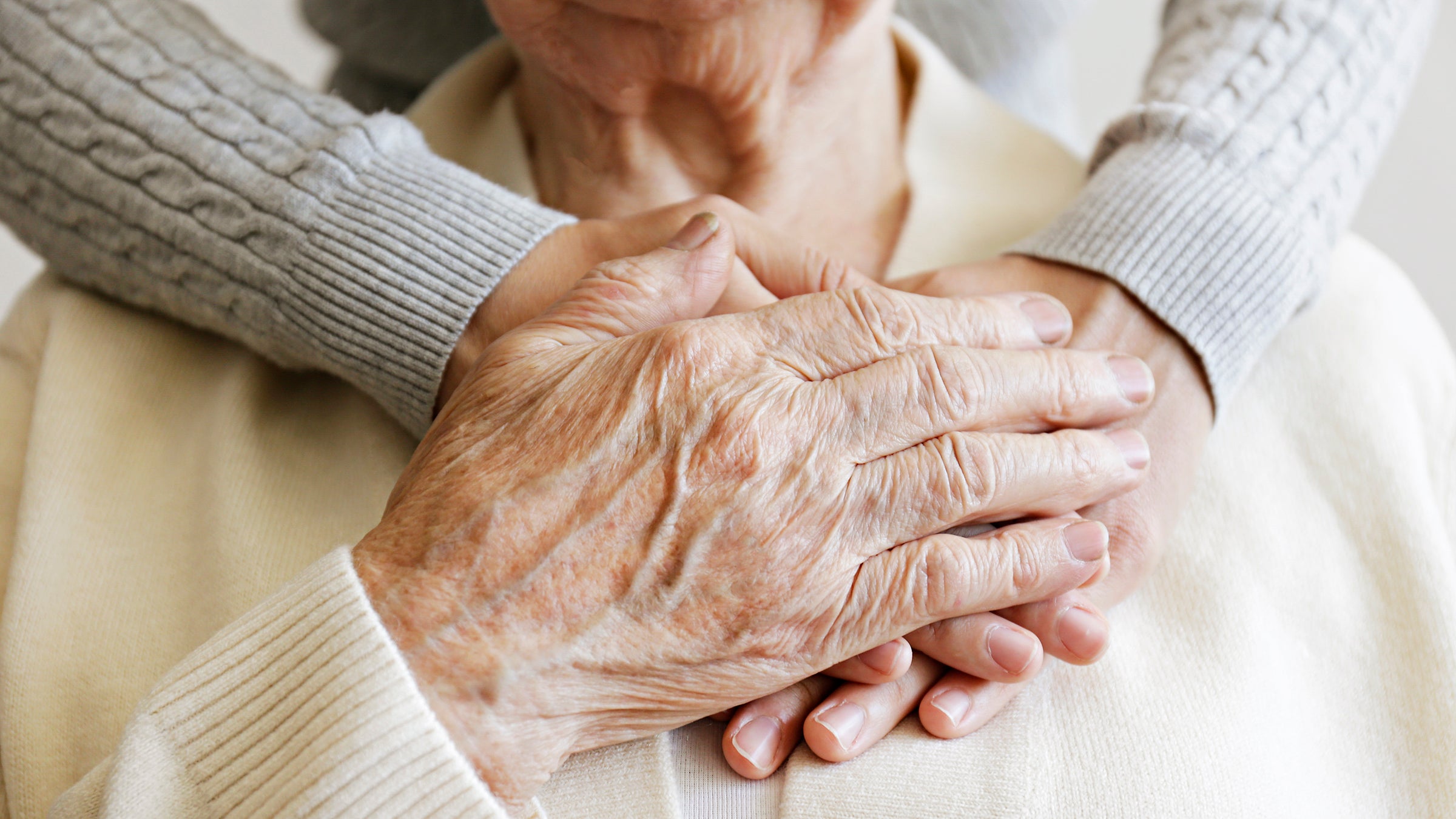 Health: patient advocacy: closeup senior woman hands holding nurses hands-1269847328