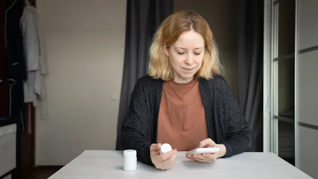 Cephalexin: woman ordering medicine on her phone 2108583342