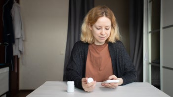 Cephalexin: woman ordering medicine on her phone 2108583342