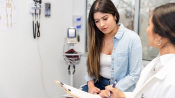 Teen Health: teenage girl at medical appointment 2099567804