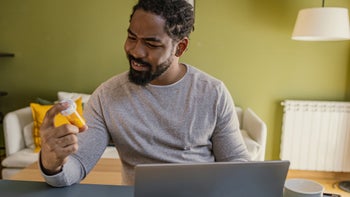 Health: Amoxicillin potassium clavulanate: man looking at prescription bottle reviewing online-1385983359