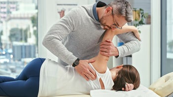 alternative treatment: chiropractor treating patient 1358954974