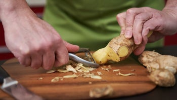 Supplements and herbs: closeup hands peeling ginger 2038216145