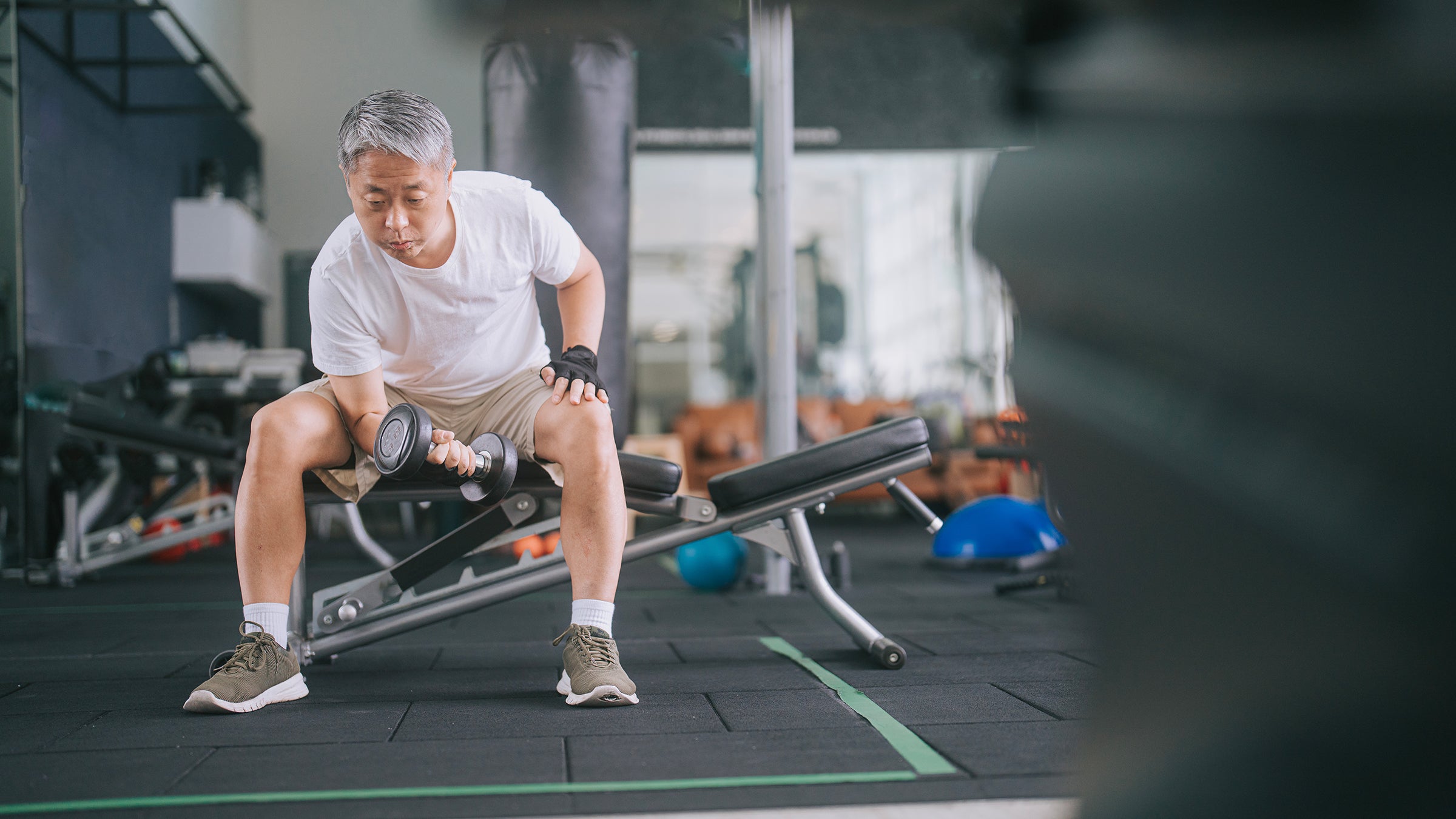 Taxes: man using dumbbell at the gym 1436388635
