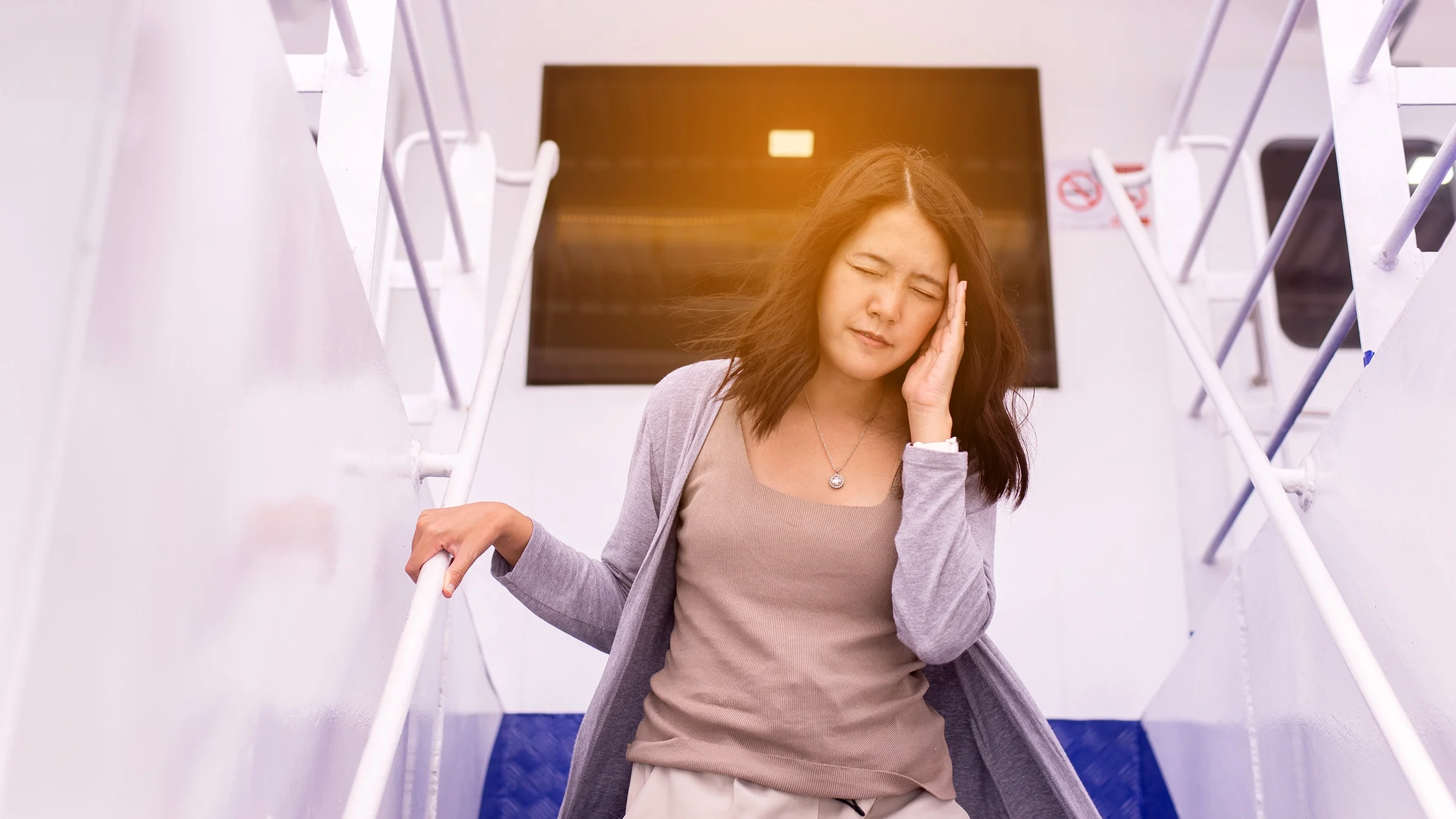A woman suffers from seasickness while on a boat.
