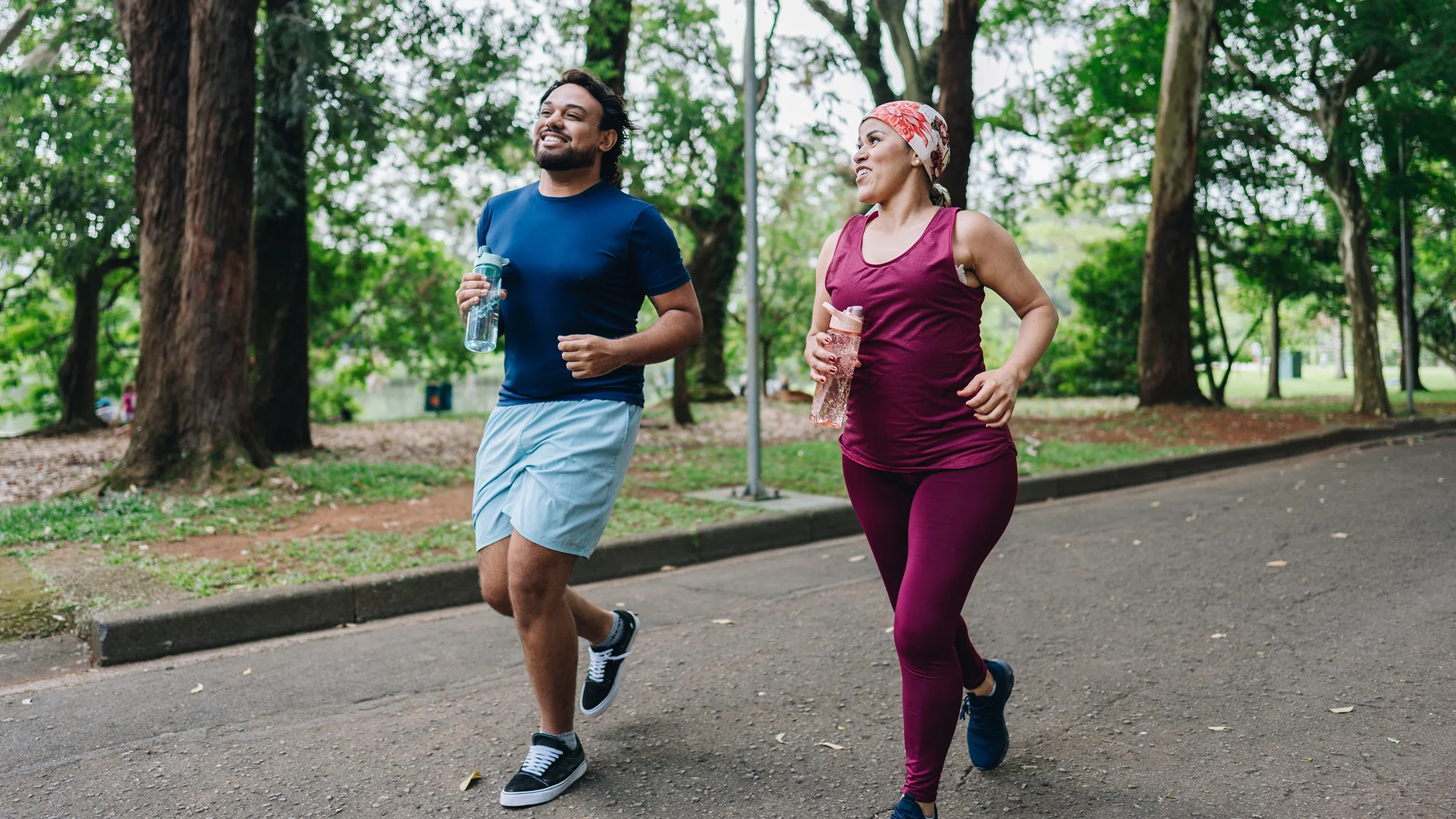 Movement and exercise: couple jogging in the park 1930005935