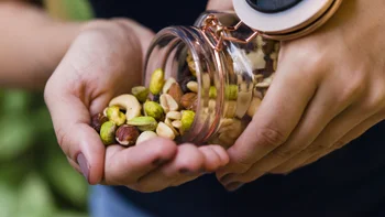 diet-nutrition: closeup nuts in hands 1136727971