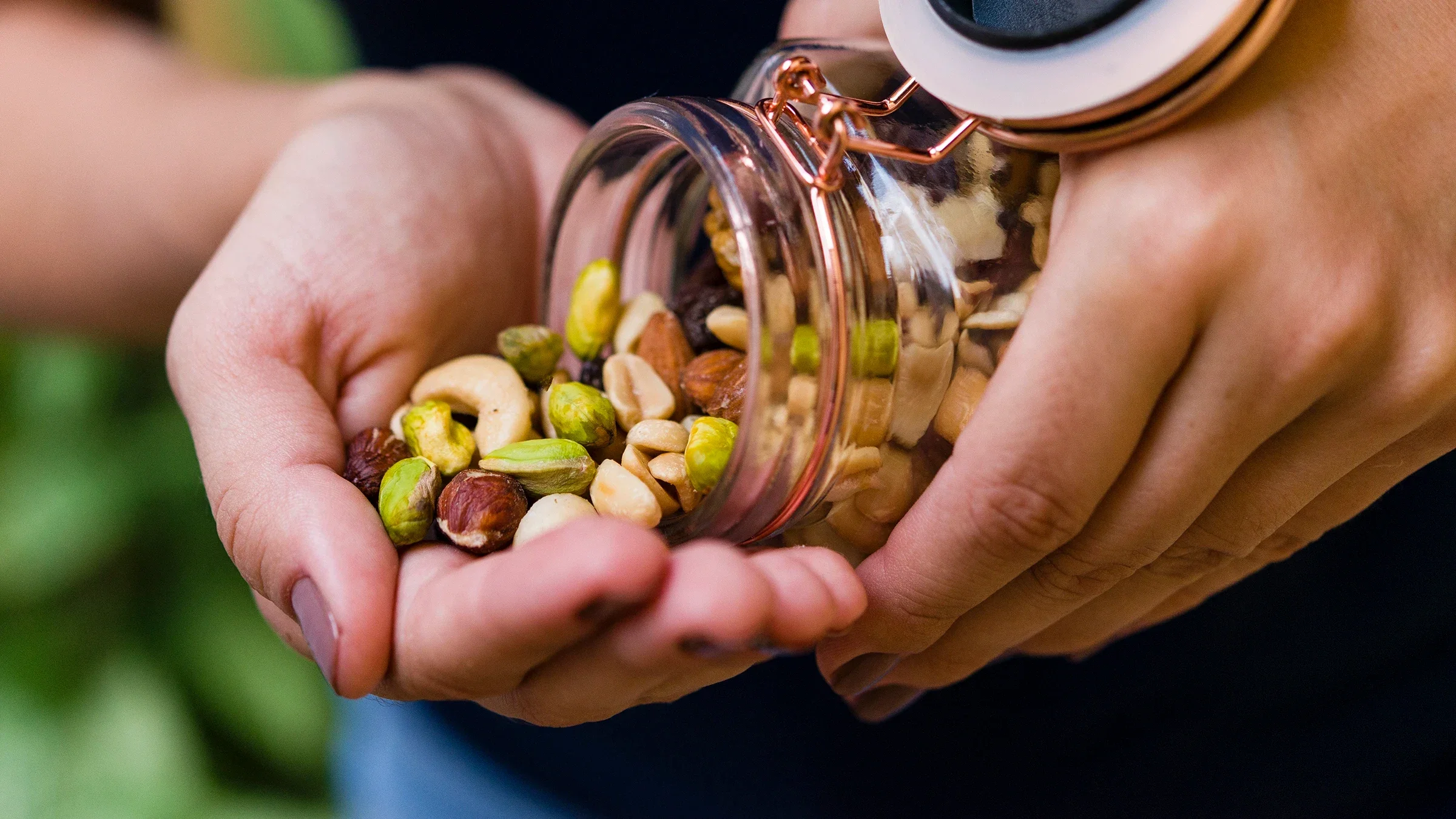 Close-up pouring nuts into palm of the hand.
Julio Ricco/iStock via Getty Images Plus