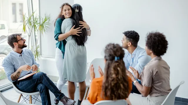 substance-use-disorder: addiction: support group two people hugging-1335296063