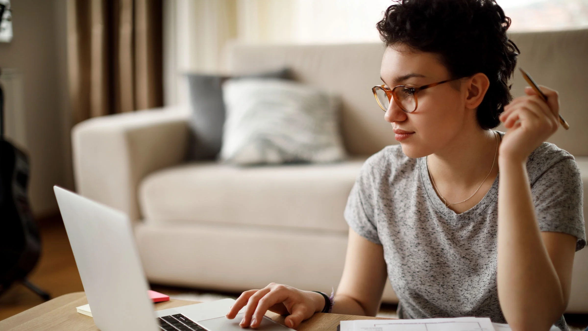 Woman working on laptop at home.