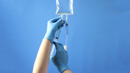 An IV bag with a syringe is shown in a close-up.
Jeniffer Fontan/iStock via Getty Images Plus     