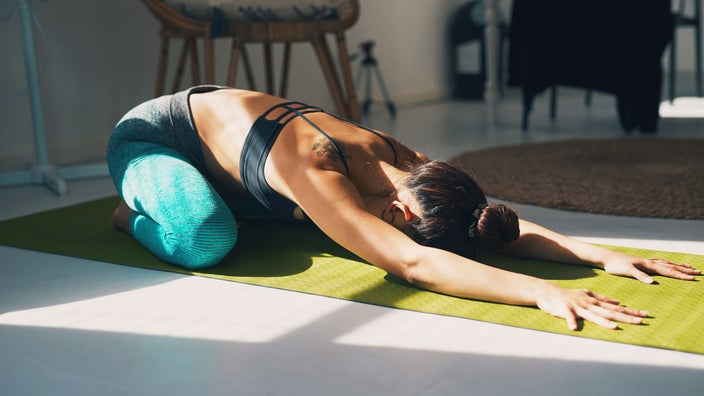 Woman practicing yoga at home.