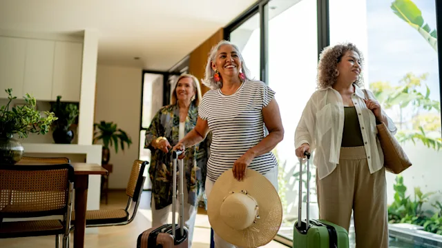 health-insurance: women arriving at vacation rental 2219822410