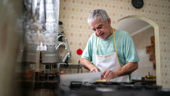prostate cancer: senior man cutting vegetables at home 1457442017