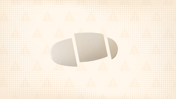 Light-cream-colored background with texture and warning sign pattern. In the center is an oval pill cut into thirds. 
