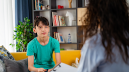 A child is at a counseling session.
Phynart Studio/E+ via Getty Images