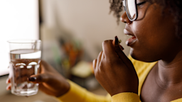 A woman taking an oral medication.
fotostorm/E+ via Getty Images