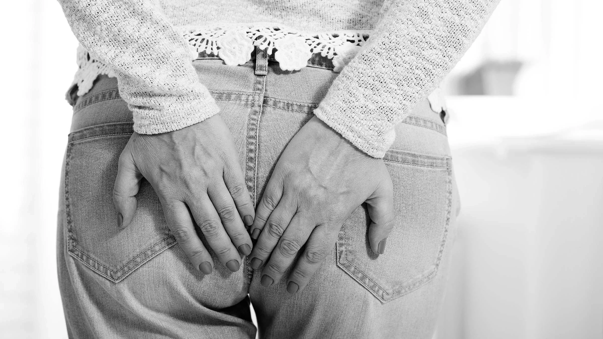 Close-up of a person holding their butt. It looks like they have the sudden urge to go to the bathroom.
Victor_69/iStock via Getty Images