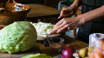 diet-nutrition: closeup hands chopping cabbage 1451664255