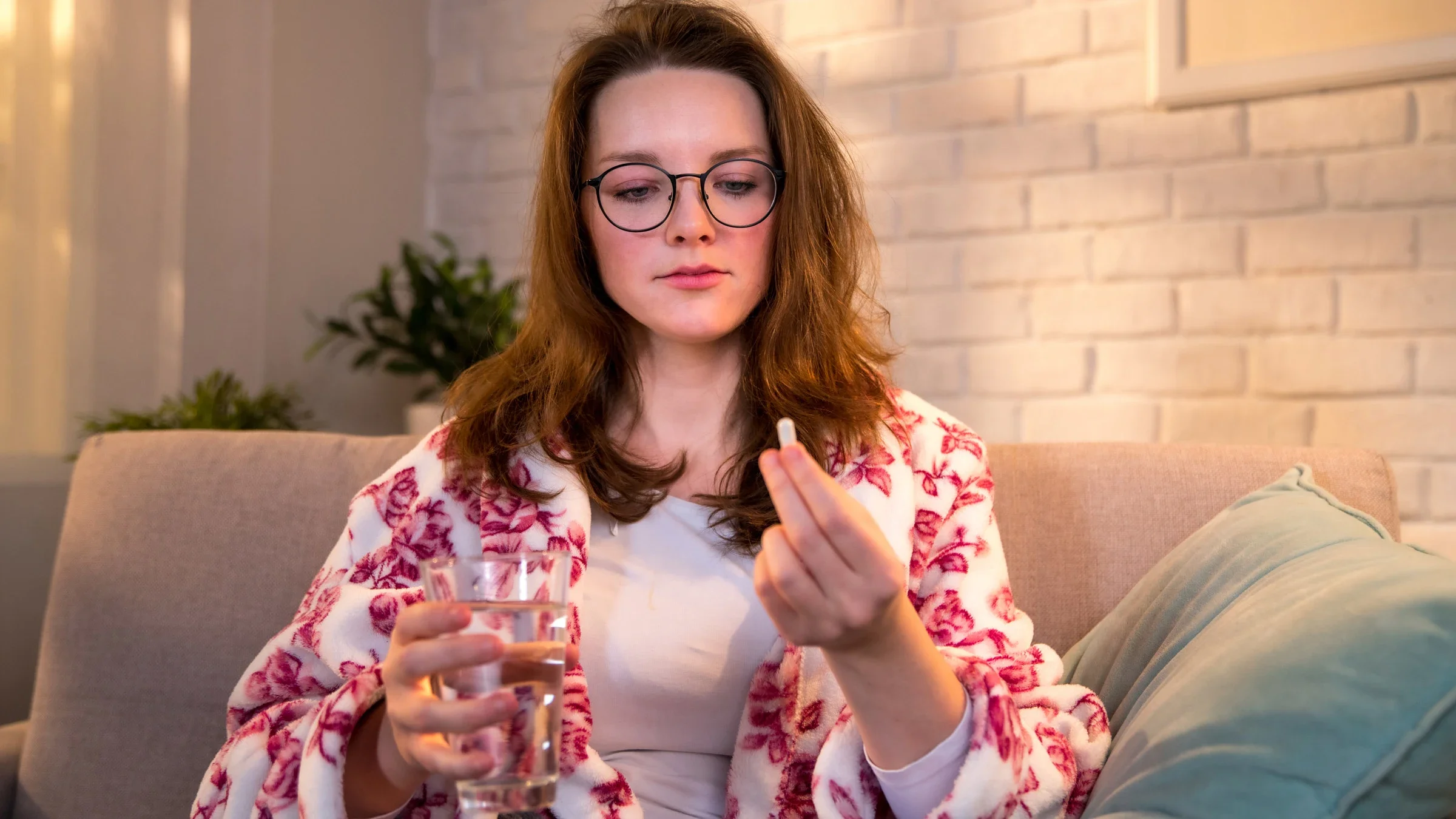 Panic disorder: Medications: taking pill on couch 1308023468