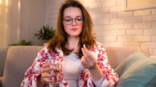 Panic disorder: Medications: taking pill on couch 1308023468