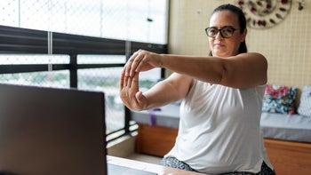 Health: Movement and exercise: woman doing wrist exercise 1328705811