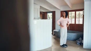 Weight-loss: woman weighing on scale 643310676