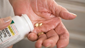aspirin: prescription: pills: aspirin in hand bottle-157397043
