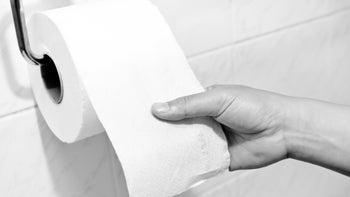 Health: Gastroenterology: black and-white toilet paper roll hand-455237921