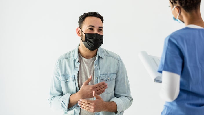 Young man consulting with his doctor in the exam room.