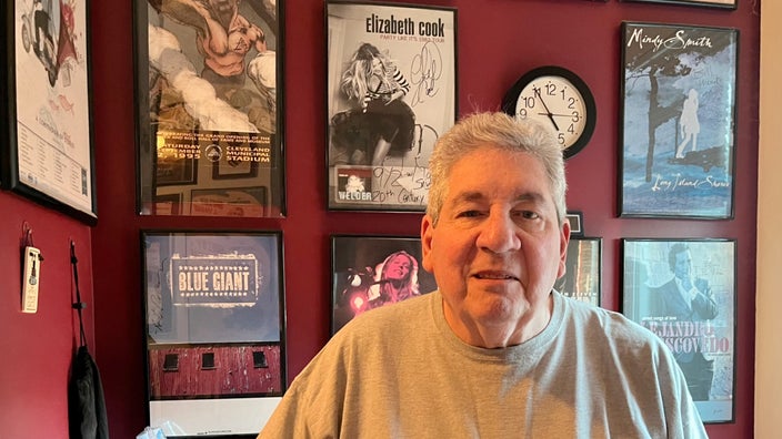 Bill Thompson is pictured at home with music posters in the background.