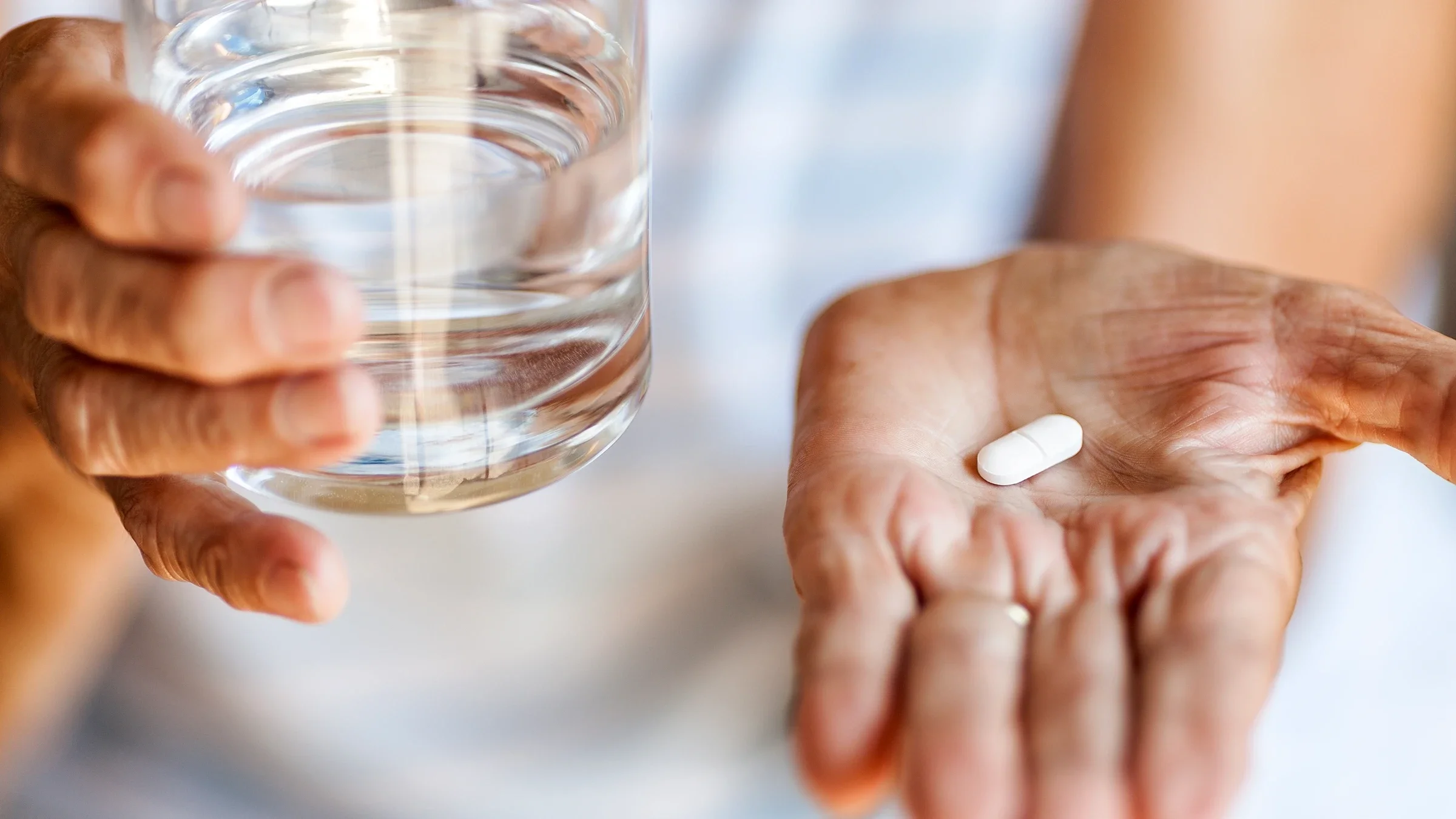 A close-up of medication in the palm of a hand.