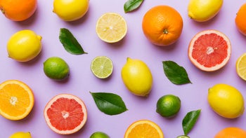 Diet nutrition: flat lay of citrus fruit on purple background 1402330770